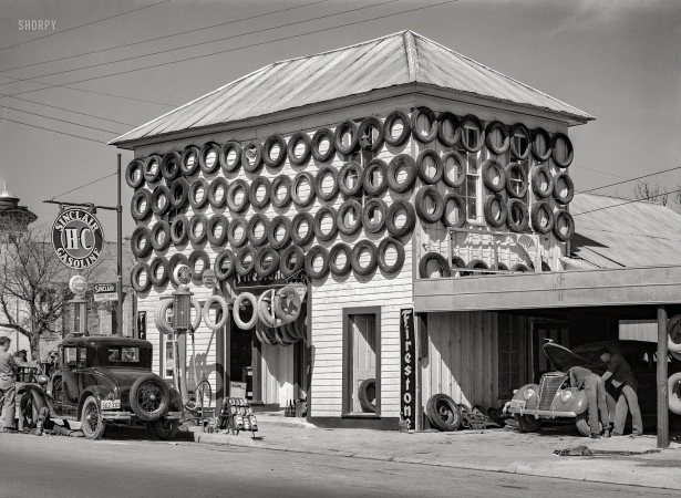 Photo showing: Re-Tirement Home -- March 1940. Secondhand tires displayed for sale at a service station in San Marcos, Texas.