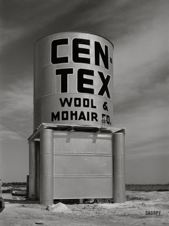 Photo showing: Big Mohair -- March 1940. Water storage tank at wool and mohair scouring plant in San Marcos, Texas.