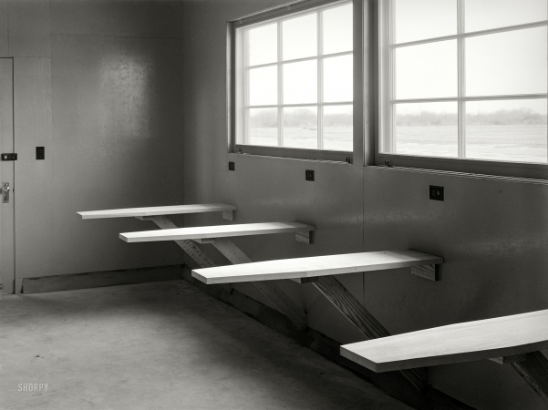 Photo showing: Board Room -- March 1940. Ironing room of migratory labor camp at Sinton, Texas.