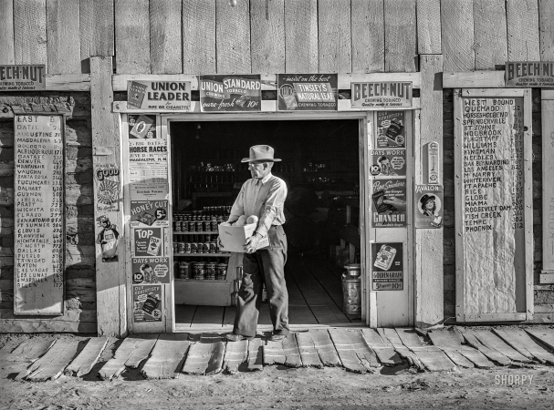 Photo showing: Pie Town Store -- June 1940.  Mr. Keele, merchant and president of the Farm
Bureau, in front of the general store. Pie Town, New Mexico.