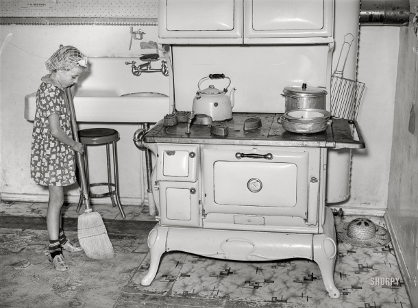 Photo showing: Kitchen Patrol -- August 1940. Daughter of Mormon farmer sweeping up the kitchen. Snowville, Utah.