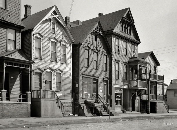 Photo showing: Frinzi Meat Market -- April 1936. Group of houses in 600 block on East Detroit Street. Milwaukee, Wisconsin.