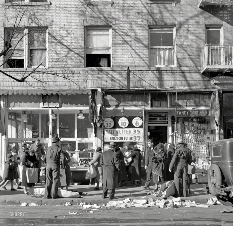 Photo showing: Fancy Groceries -- December 1936. Scene along Bathgate Avenue in the Bronx, a section
from which many of the New Jersey homesteaders have come.