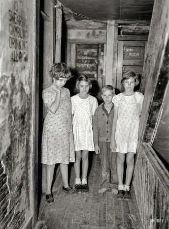 Photo showing: No Swearing Gambling Drinking -- January 1937. Children of citrus workers in hallway of apartment house. Winter Haven, Fla.