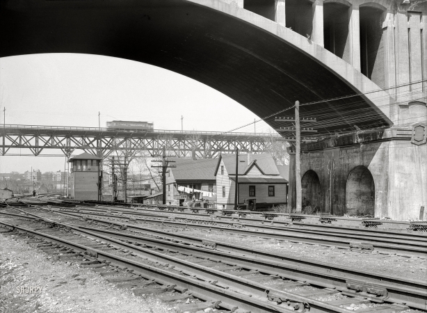 Photo showing: Over and Under -- -- April 1936. Milwaukee, Wisconsin. Housing under the Wisconsin Avenue viaduct.