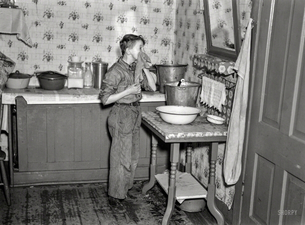 Photo showing: A Fresh Start. -- March 1937. 6:45 a.m. -- One of nine children, son of hired man Tip Estes
washing his face after doing his early-morning chores. Near Fowler, Indiana.