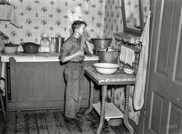 Photo showing: A Fresh Start. -- March 1937. 6:45 a.m. -- One of nine children, son of hired man Tip Estes
washing his face after doing his early-morning chores. Near Fowler, Indiana.
