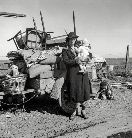 Photo showing: Rough Road -- February 1937. Missouri family of five, seven months from the drought
area. 'Broke, baby sick, car trouble.' U.S. 99 near Tracy, California.