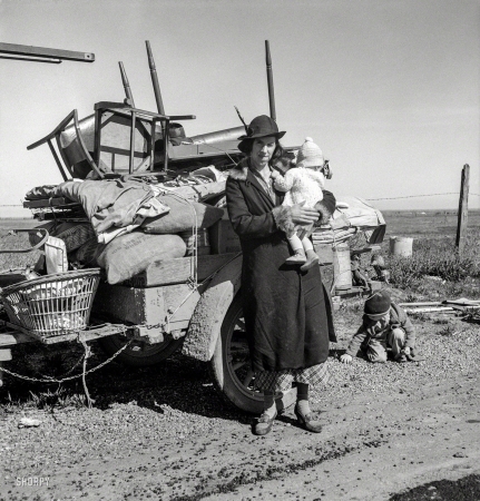 Photo showing: Rough Road -- February 1937. Missouri family of five, seven months from the drought
area. 'Broke, baby sick, car trouble.' U.S. 99 near Tracy, California.