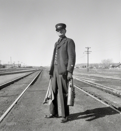 Photo showing: Make It Stop -- June 1939. West Carlin, Nevada. Brakeman on the Union Pacific Challenger.