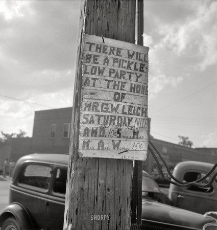 Photo showing: Pickle-Low Party -- July 1939. Sign tacked to pole near the post office. Main street, Pittsboro, North Carolina.