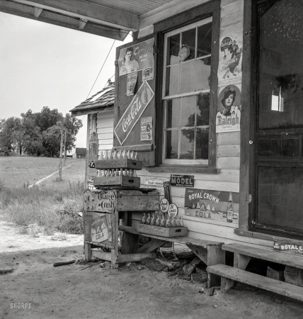Photo showing: Mom-and-Pop -- July 1939. Granville County, North Carolina. Country filling station owned by tobacco farmer.