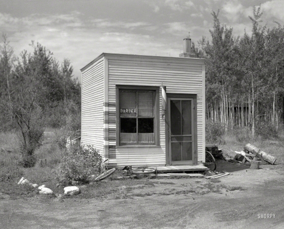 Photo showing: Twig Barber -- August 1937. Barbershop in village of Twig, Minnesota.