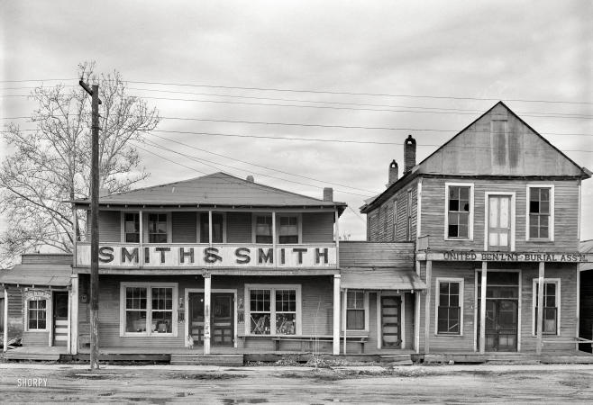 Photo showing: Knock, Knock. -- January 1939. Businesses in Mound Bayou, Mississippi.
