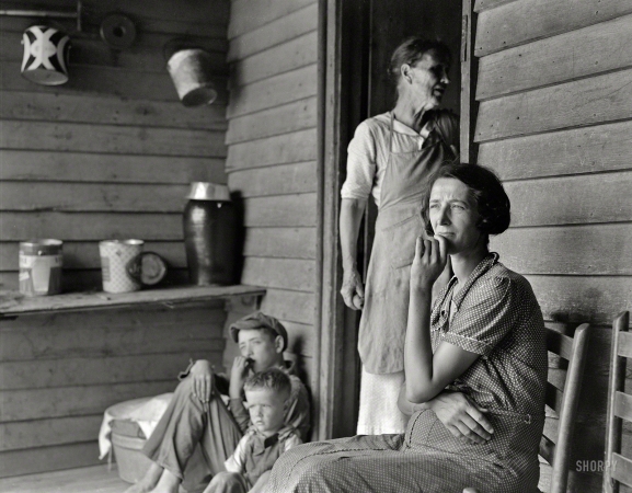 Photo showing: The Matriarchs -- July 1937. Sharecropper's wife, mother of seven. Woman in doorway is mother
of fourteen, ten living; fifty-six grandchildren. Near Chesnee, South Carolina.