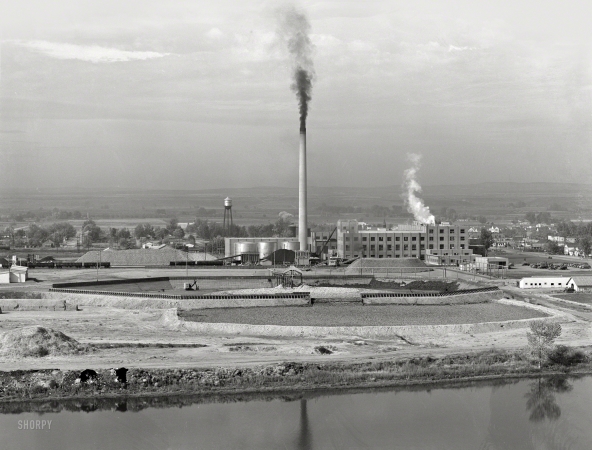 Photo showing: A Billion Beets -- October 1939. Sugar beet factory along Snake River. Shows beet dump, beet pile. Nyssa, Malheur County, Oregon.