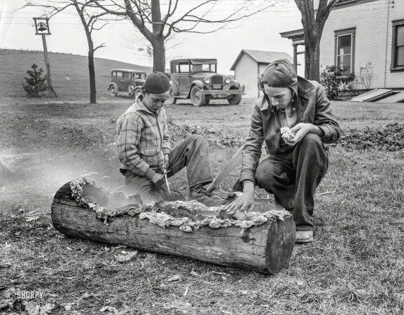 Photo showing: Smoking a Log -- April 1935. Boys smoking log. Reedsville, West Virginia.