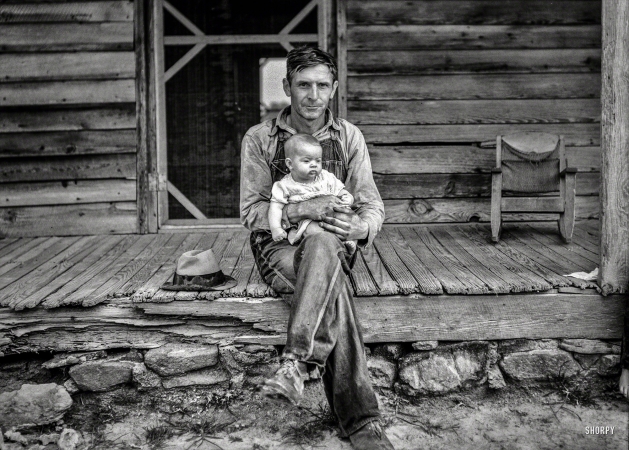Photo showing: Baby, Daddy -- July 1939. Mr. Whitfield, tobacco sharecropper, with baby. Person County, N.C.