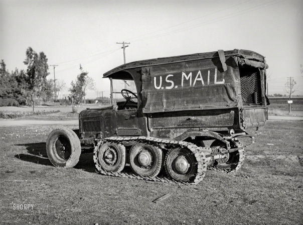 Photo showing: Neither Snow Nor Mud -- November 1940. U.S. Mail truck used in snowy mountain sections of Nevada County, California.
