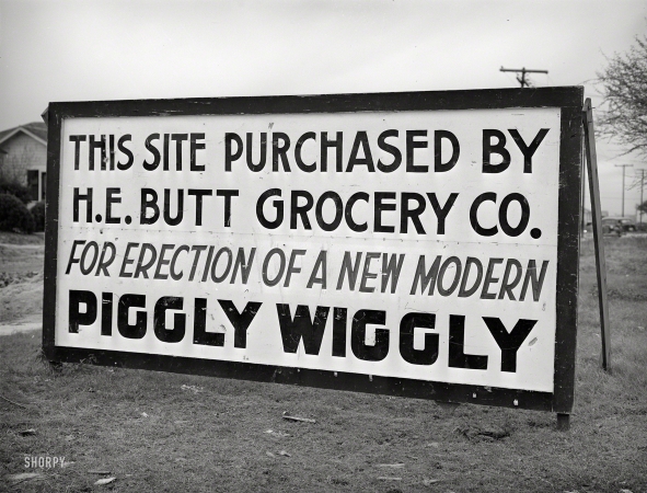 Photo showing: Butt Wiggly -- December 1940. Corpus Christi, Texas. Sign announcing new grocery store in
community springing up about five miles from the naval air base under construction.
