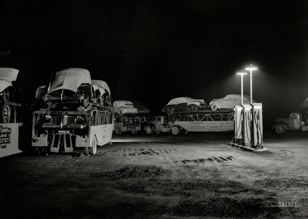 Photo showing: Night Moves. -- April 1941. Auto convoy trucks at service station near Chicago.