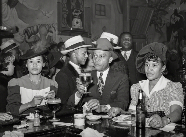 Photo showing: Dwarfed -- April 1941. South Side Chicago. Scene in Negro tavern. The walls
adorned with murals from the Disney version of Snow White.
