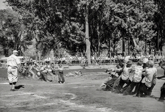 Photo showing: High Tension -- July 1941. Kids' tug-of-war at the Fourth of July celebration at Vale, Oregon.