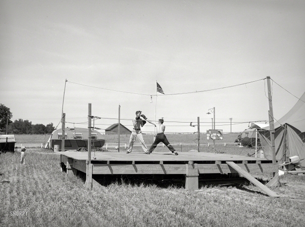 Photo showing: Fight Camp -- June 1941. Transient workers. Boxing platform at FSA migratory farm labor camp mobile unit. Athena, Oregon.