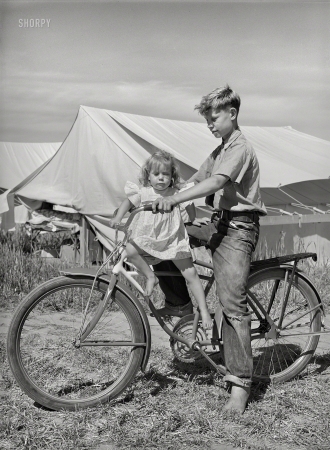 Photo showing: Big Bruvver -- July 1941. Children outside tent home at the FSA migratory farm labor camp mobile unit. Athena, Oregon.