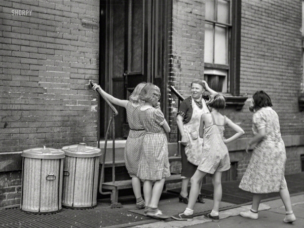 Photo showing: Trash Talk -- New York, 1938. Woman and girls at the back of an apartment house on East 63rd Street.