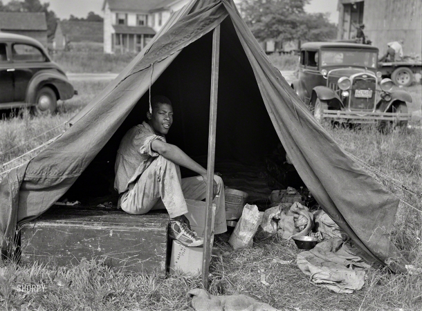 Photo showing: Sick Kicks -- July 1940. Florida agricultural migrant with a group who had their own tent,
which they pitched outside the grading station at Belcross, North Carolina.