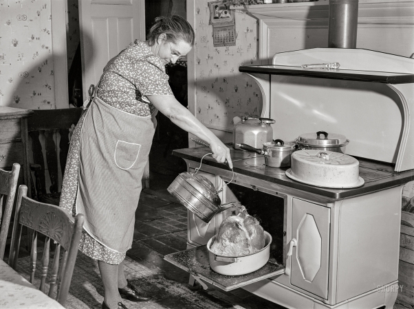Photo showing: Basting the Bird. -- November 28, 1940. Mrs. T. M. Crouch, of Ledyard, Connecticut,
pouring some water over her twenty-pound turkey on Thanksgiving Day.