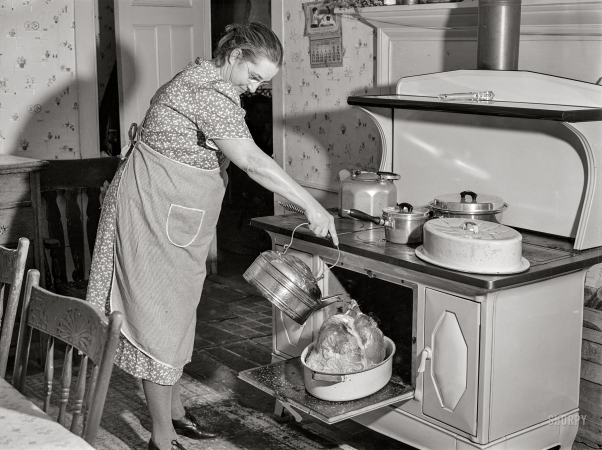 Photo showing: Basting the Bird. -- November 28, 1940. Mrs. T. M. Crouch, of Ledyard, Connecticut,
pouring some water over her twenty-pound turkey on Thanksgiving Day.