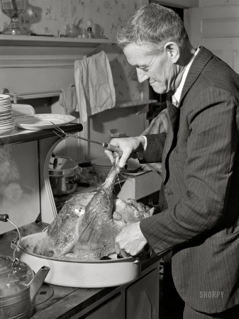 Photo showing: Carving the Bird -- November 1940. Ledyard, Connecticut. Mr. T.L. Crouch,
a Rogerine Quaker, preparing to carve the Thanksgiving turkey.