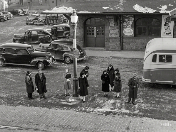 Photo showing: Mass. Transit - -- January 1941. Commuters who have just gotten off the train waiting for the bus to go home. Lowell, Massachusetts.