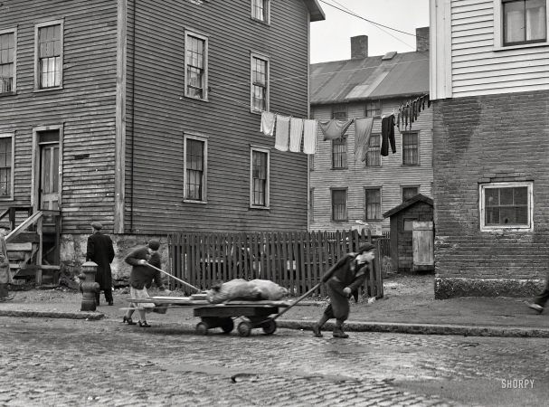 Photo showing: Woody Wagon -- January 1941. New Bedford, Mass. Bringing home some salvaged firewood in a slum area.
