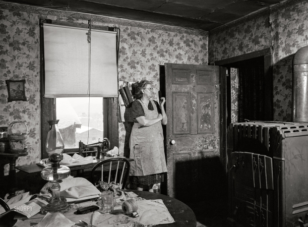 Photo showing: Fade to Black -- January 1940. Woman in dilapidated old house in the Mount Washington
district of Beaver Falls, Pennsylvania. She is blind in one eye and ... 