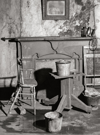 Photo showing: Water Lilies -- January 1940. Buckets placed in room to catch water from leaky ceiling
in a house in Mount Washington district. Beaver Falls, Pennsylvania.