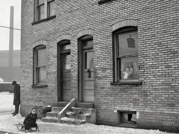 Photo showing: Ice Baby -- January 1941. Workers' houses near Pittsburgh Crucible Steel Company in Midland, Pennsylvania.