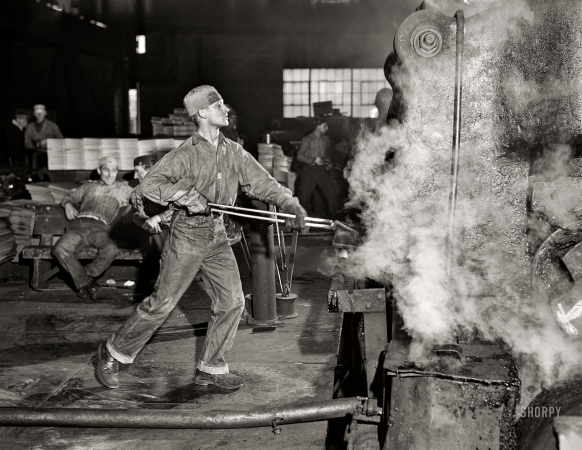 Photo showing: Hot Jobs -- January 1941. Washington, Pa. At one of the rolling machines in the Washington Tinplate Co.