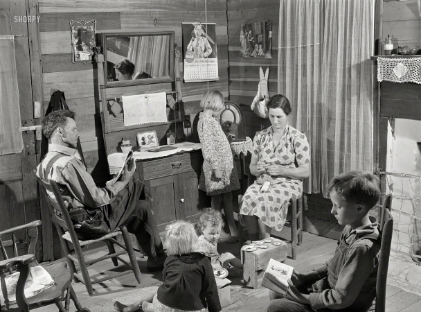 Photo showing: The Family Room -- April 1941. Mr. and Mrs. Lemuel Smith and their younger children in their farm house, Carroll County, Georgia.