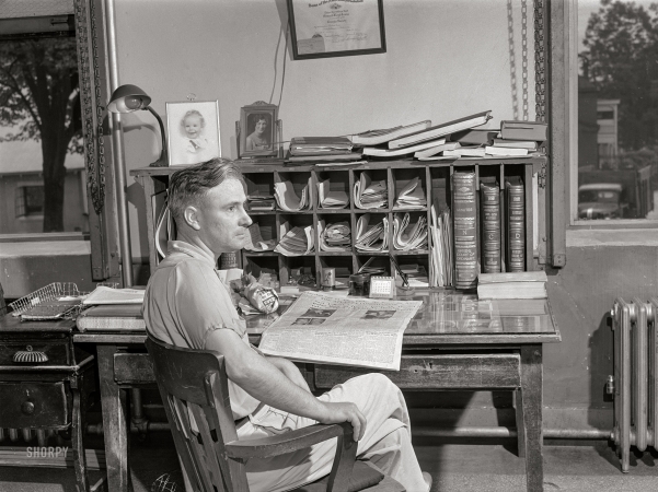 Photo showing: County Ordinary -- June 1941. Mr. Lloyd Lewis, Greene County ordinary, in his office in Greensboro, Georgia.