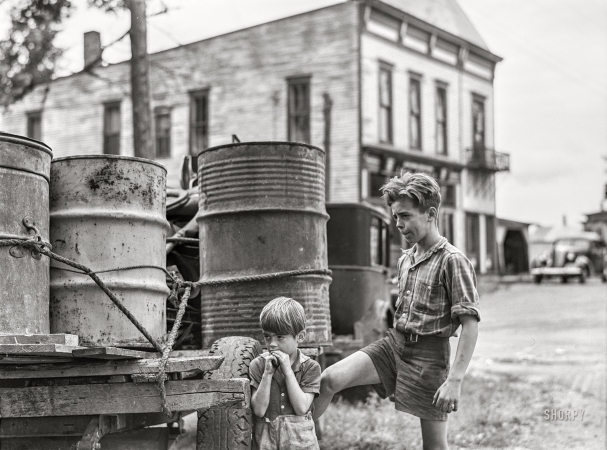 Photo showing: Pine Camp -- August 1941. Two of the children of Mr. Earl J. Brown helping to get the last few
belongings out of their farm in the Pine Camp expansion area near Watertown, New York.