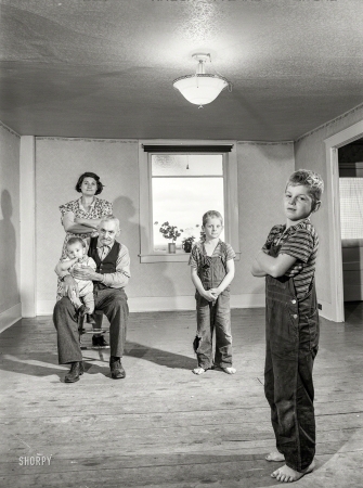 Photo showing: Modern Family: 1941 -- October 1941. Mrs. Melvin Rivers, some of her children and her father-in-law in their
new relocation corporation farm to which they have moved, near Orwell, New York.