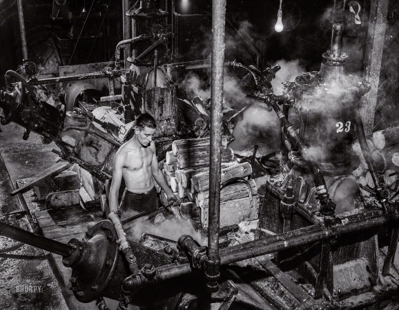 Photo showing: Pulp Friction -- September 1941. One of the machines that grind wood into pulp
at the Mississquoi Corporation paper mill at Sheldon Springs, Vermont.