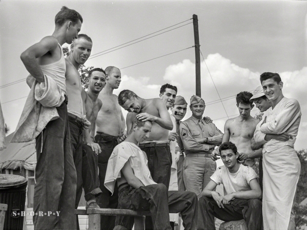 Photo showing: High and Tight. -- June 1941. Hattiesburg, Mississippi. Getting a haircut at Camp Shelby.
