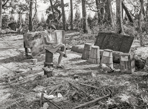 Photo showing: House, Boy, Shose -- January 1939. Migratory packinghouse worker's child playing 'school' near Canal Point, Florida.