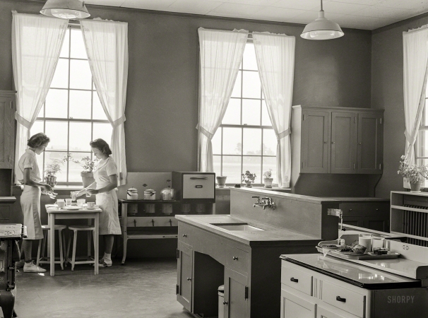 Photo showing: Dot and Liz -- May 1939. Dorothy Smith and Elizabeth Atkinson setting the table in
home economics room in school building. Ashwood Plantations, South Carolina.