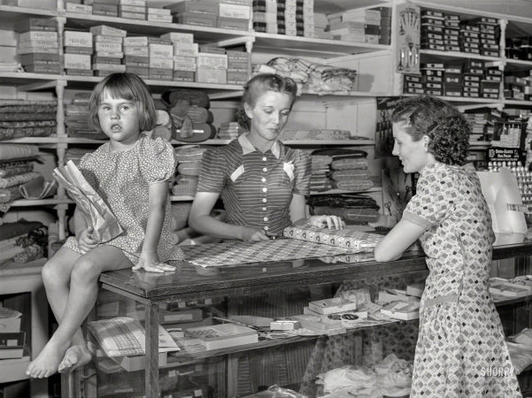 Photo showing: La. Ladies -- June 1940. Buying dress goods in project cooperative store. Transylvania Resettlement Project, Louisiana.