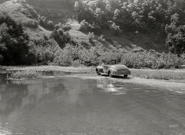 Photo showing: I Auto Be in Pictures -- September 1940. Car fording creek up Morris Fork of the Kentucky River.
Photographer Marion Post Wolcott in her Oldsmobile.